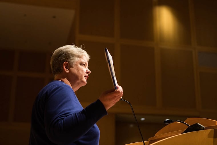 Sister Janet McCann of the Adorers of the Blood of Christ holds up the Pope Francis encyclical “Laudato Si” while addressing attendees at the National Constitution Center on Friday, January 19, 2018. The nuns have filed a religious freedom suit against the federal government and owners of a pipeline on their property.