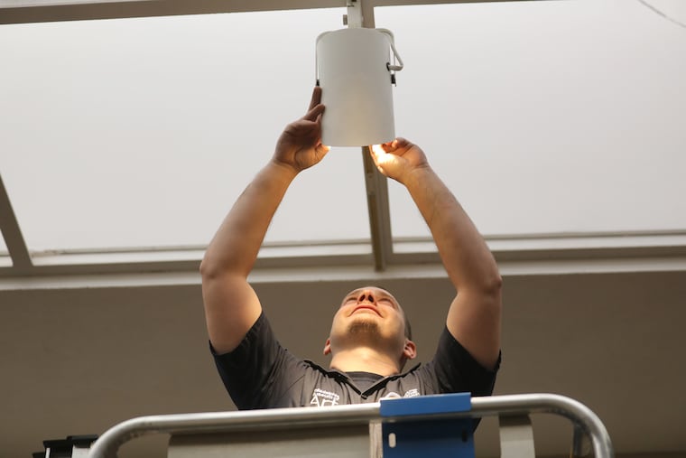 Worker Robert Chilson installs LED lighting at The Philadelphia Museum of Art last month.