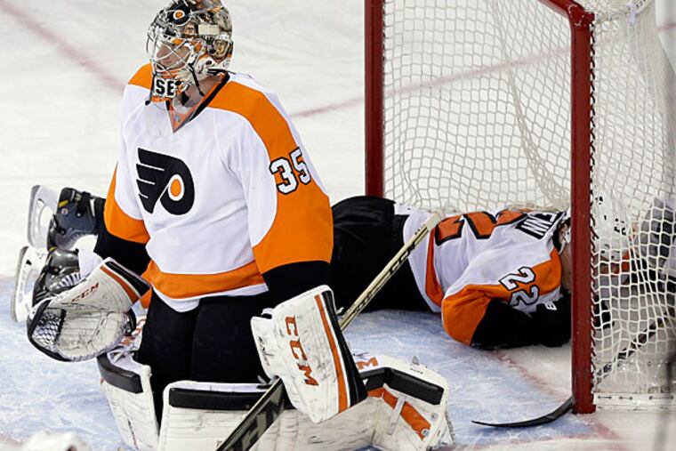 Flyers goalie Steve Mason and teammate Luke Schenn. (Frank Franklin II/AP)
