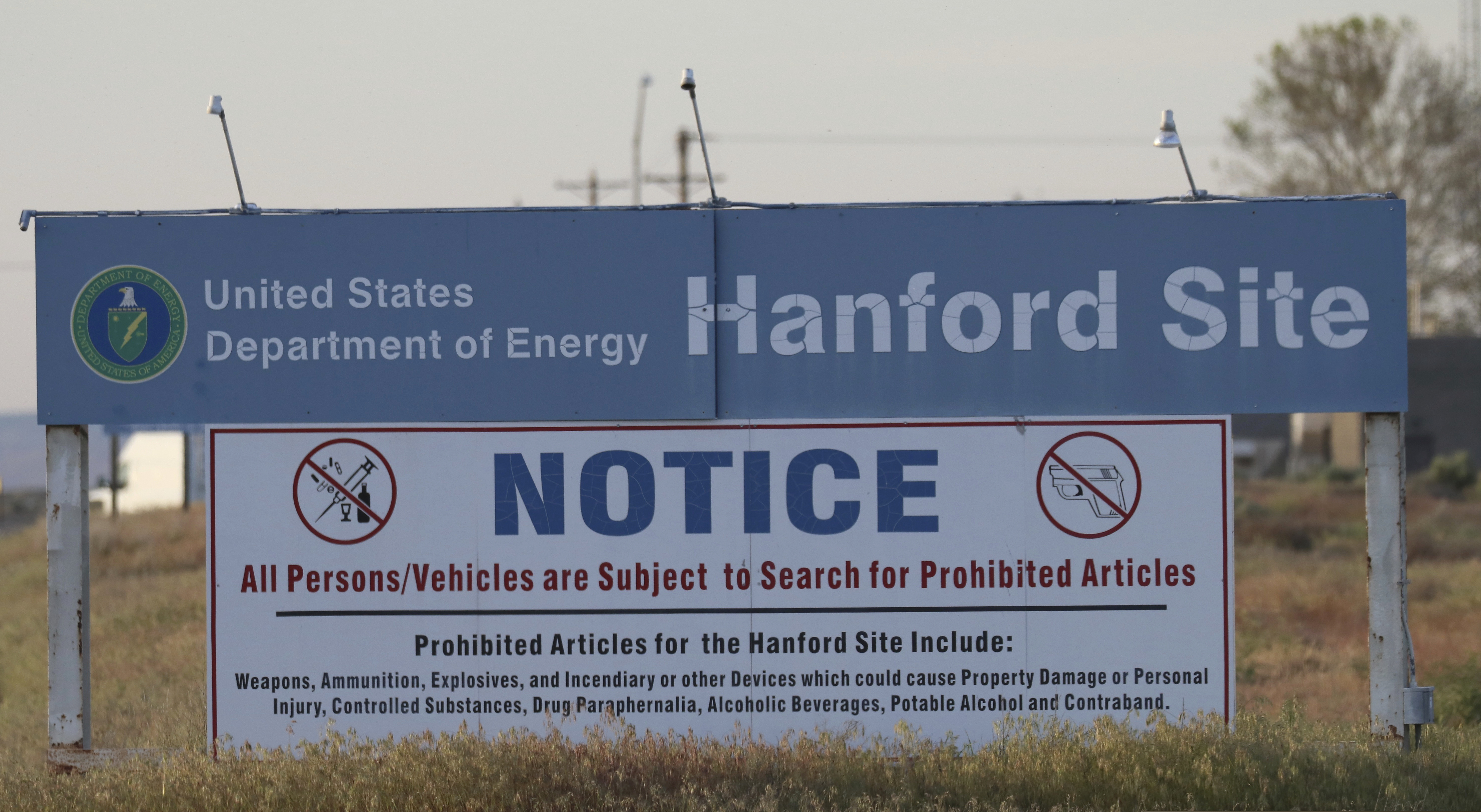 FILE: In this file photo from Tuesday, May 9, 2017, signs are posted by the Hanford Nuclear Reservation in Richland, Wash. State officials this week filed their objections to a Trump administration plan to reclassify millions of gallons of waste stored in underground tanks at Hanford Nuclear Reservation. (AP Photo/Manuel Valdes)