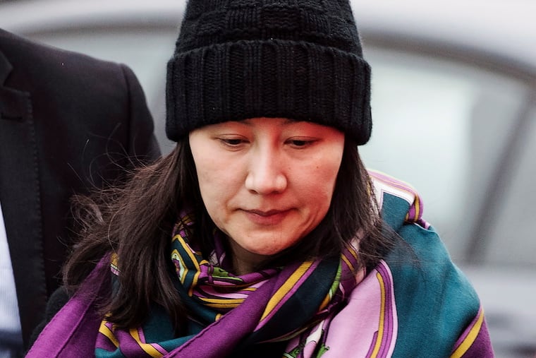 FILE - In this Dec. 12, 2018, file photo, Huawei chief financial officer Meng Wanzhou arrives at a parole office with a security guard in Vancouver, British Columbia. China on Tuesday, Jan. 22, 2019, demanded the U.S. drop a request that Canada extradite the top executive of the tech giant Huawei, shifting blame to Washington in a case that has severely damaged Beijing’s relations with Ottawa. (Darryl Dyck/The Canadian Press via AP, File)