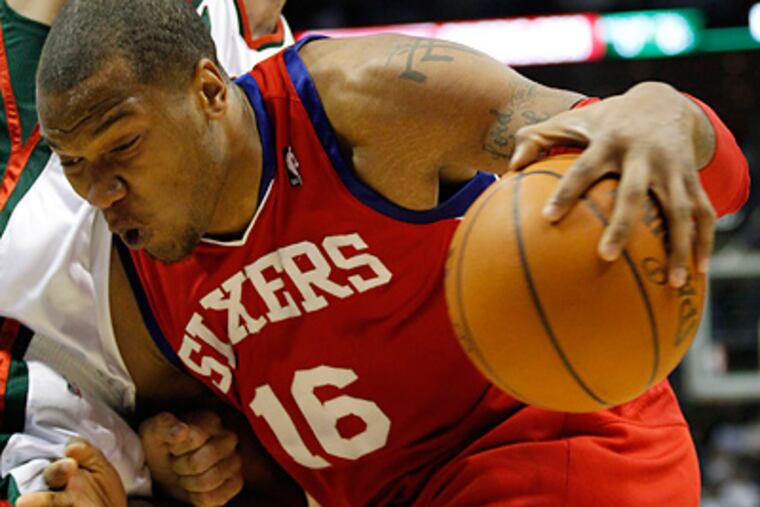 Marreese Speights (16) drives to the basket against the Milwaukee Bucks' Andrew Bogut. (AP Photo/Jeffrey Phelps)