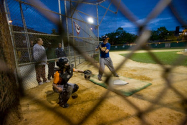 Narda Quigley, 30 is behind the plate as Katie Gold takes batting practice. The women play in the Philadelphia Women's Baseball League, which Quigley helped found five years ago. Two years ago, she attended Phillies Baseball 101 for Women for the first time.