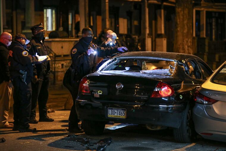 Police look over the crime scene at 2858 N. 26th Street in the 39th Police District where a 35 year-old male was fatally shot multiple in a car at about 6:45pm, Wednesday, November 25, 2020