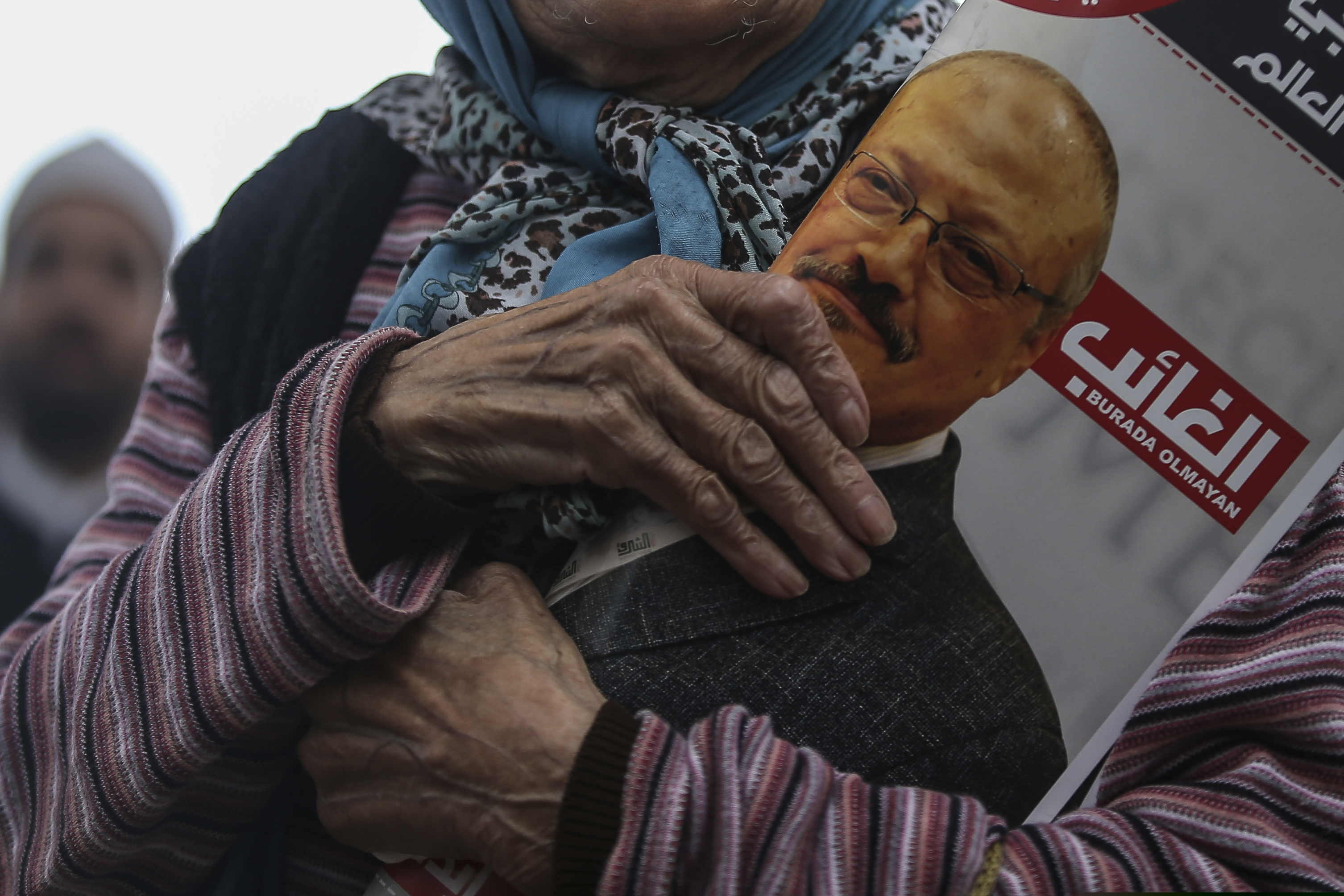 A woman on Friday holds a poster during the funeral prayers in absentia for Saudi writer Jamal Khashoggi who was killed last month in the Saudi Arabia consulate in Istanbul.
