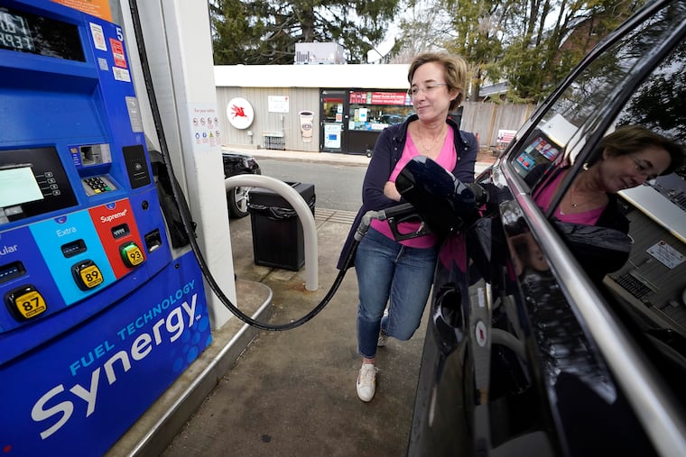 Jennifer Quinn filling her SUV at a gas station in March in Needham, Mass.