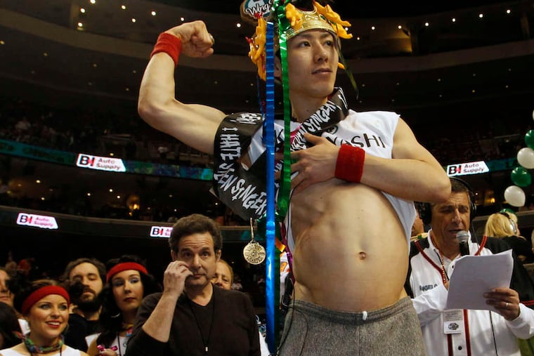 Wing Bowl champion Takeru Kobayashi shows off his generous stomach. Generous himself, he donated more than $3,000 of his winnings to Philabundance.
