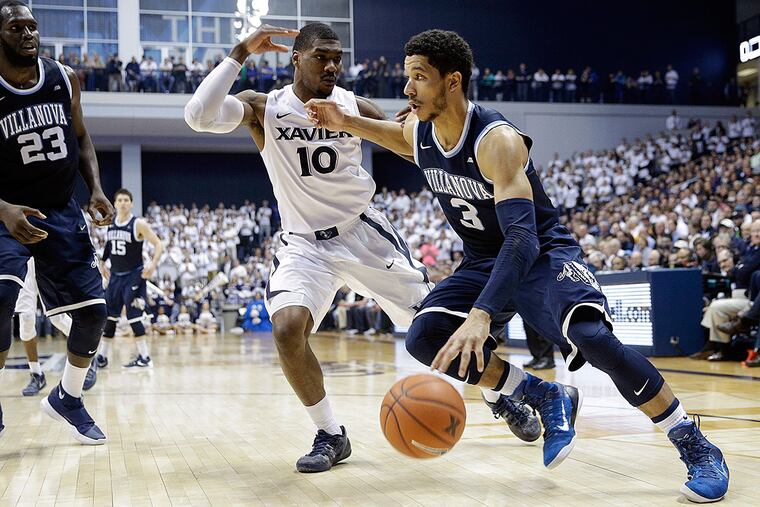 Villanova's Josh Hart (3) drives against Xavier's Remy Abell (10) as Daniel Ochefu (23) looks on during the first half of an NCAA college basketball game, Wednesday, Feb. 24, 2016, in Cincinnati.