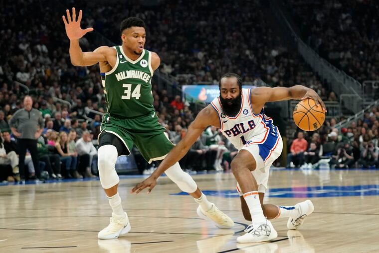 Philadelphia 76ers' James Harden (1) dribbles against Milwaukee Bucks' Giannis Antetokounmpo during the first half of an NBA basketball game Saturday, March 4, 2023, in Milwaukee.