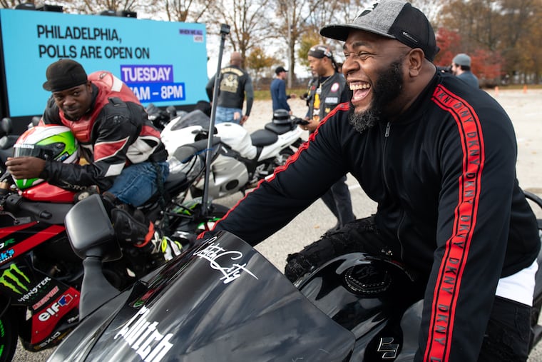 Dame Johnson (left) and “Mr. Huss” (right) sit on their motorcycles before the motorcycle ride and party at the polls event at Enon Baptist Church in Philadelphia on Saturday, Nov. 5, 2022. The event was hosted by When We All Vote and several local organizations to encourage voting in the upcoming midterm election.