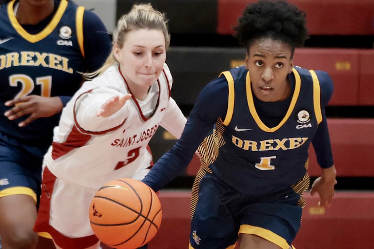 Emma Boslet of St. Joseph's tries to tip the ball from Drexel’s Keishana Washington during a game earlier this season.