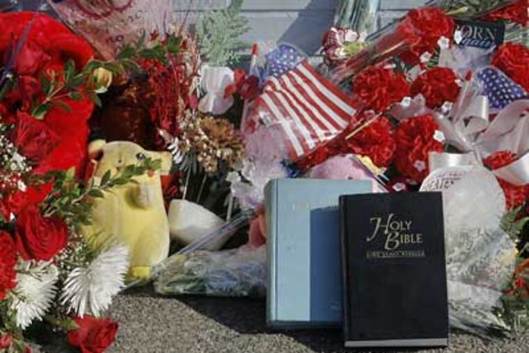 A makeshift shrine sits at Broad and Olney Streets near where Officer John Pawlowski was slain Friday. (Akira Suwa / Staff Photographer)