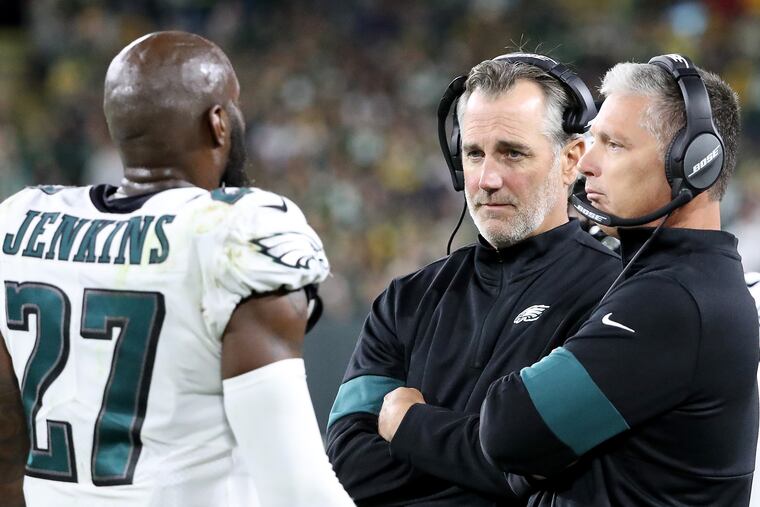 Eagles safety Malcolm Jenkins (left) talks with defensive backs coach Cory Undlin (center) and defensive coordinator Jim Schwartz during a game in September.