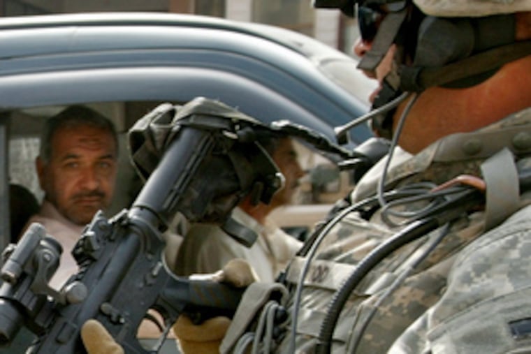 A U.S. soldier mans a checkpoint in central Baghdad. The troops' commander, Gen. David Petraeus, was on Capitol Hill yesterday, telling members of Congress that the increased troop strength in Iraq was yielding mixed results and needed more time to work.