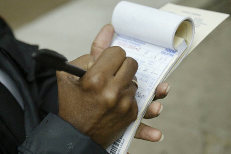 FILE - A Parking Authority employee writes tickets on Walnut Street. (Jennifer Midberry/Daily News, File)