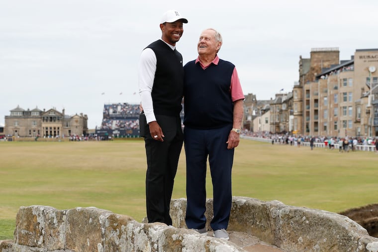 Tiger Woods, left, and Jack Nicklaus, both from the United States pose for a photo on the Swilken Bridge during a 'Champions round' as preparations continue for the British Open golf championship on the Old Course at St. Andrews, Scotland, Monday July 11, 2022. The Open Championship returns to the home of golf on July 14-17, 2022, to celebrate the 150th edition of the sport's oldest championship, which dates to 1860 and was first played at St. Andrews in 1873. (AP Photo/Peter Morrison)