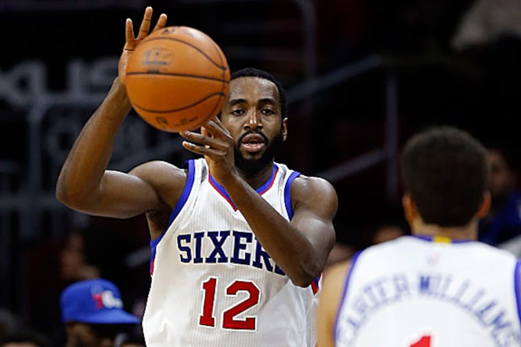 76ers forward Luc Mbah a Moute passes to point guard Michael Carter-Williams. (Yong Kim/Staff Photographer)