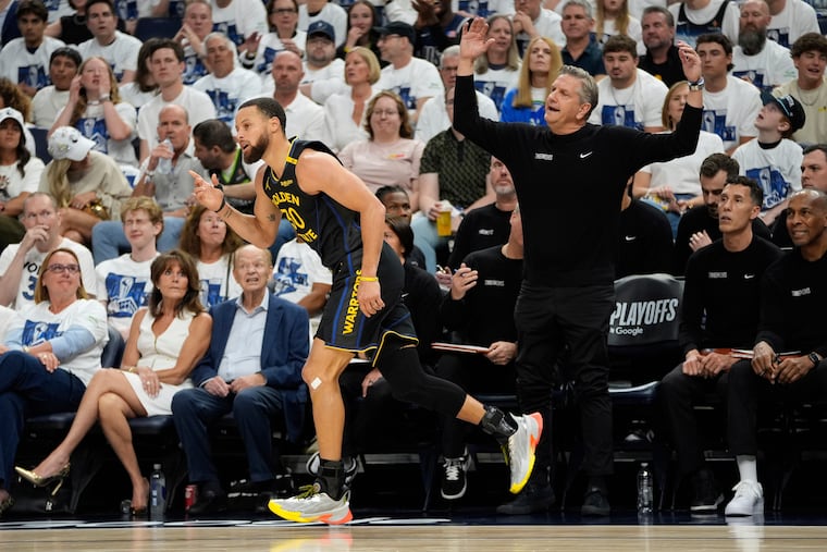 Warriors guard Stephen Curry reacts after making a three-pointer against the Timberwolves during Game 1 of their series.
