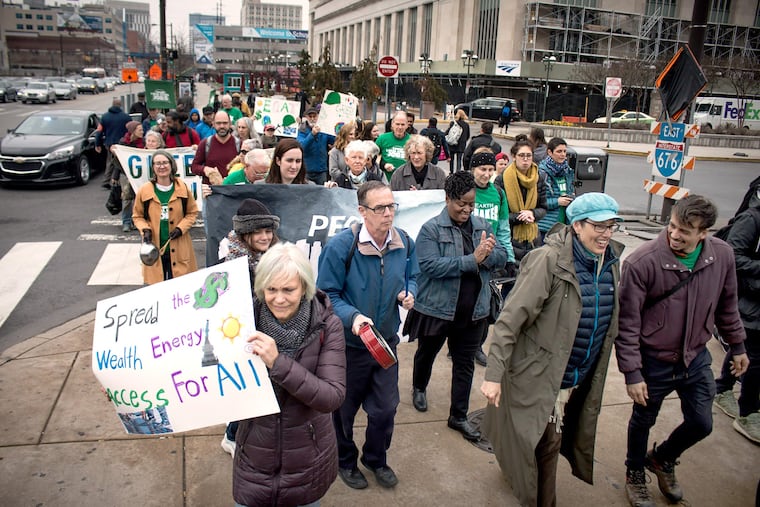 Members of the Earth Quaker Action Team (EQAT) march on Peco Energy headquarters in a protest that's part of its ongoing campaign for solar energy and green jobs.
