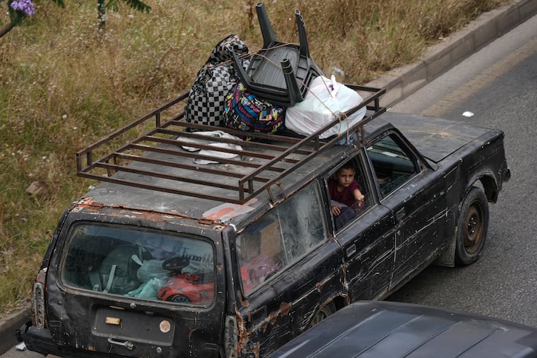 A family flees following an Israeli threat to strike Dahiyeh, Beirut's southern suburbs, Lebanon, Monday, June 1, 2026.
