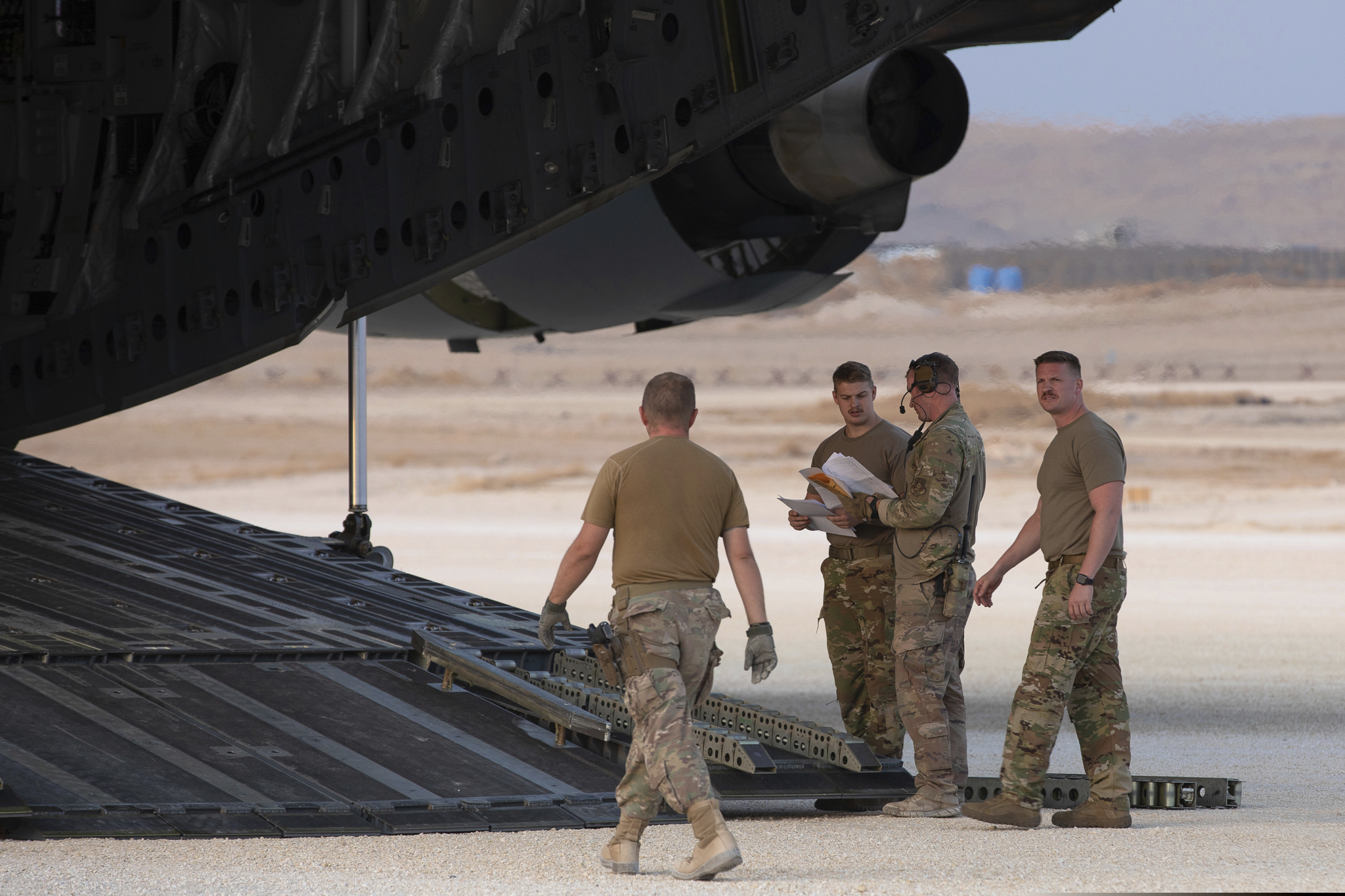 In this Oct. 24, 2019, photo, released by the U.S. Army Reserve, U.S. Airmen check their manifest for military equipment to be loaded onto a cargo plane at Kobani Landing Zone (KLZ), Syria. The 225,000 American troops stationed worldwide could be impacted by the Trump Administration's proposed cuts to the International Affairs Budget.