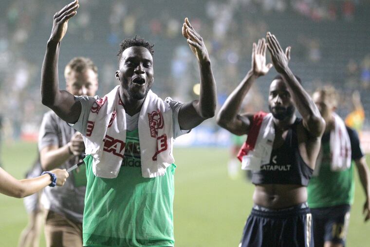 CJ Sapong, left, and Warren Creavale of the Union celebrate their victory over the Revolution at Talen Energy on Saturday.