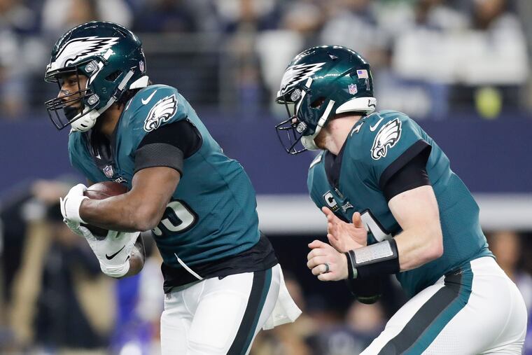 Josh Adams takes the handoff from Carson Wentz during the Eagles' loss to the Cowboys this week.