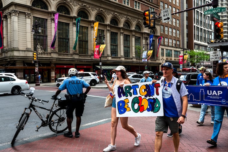 University of the Arts students, staff, and faculty march past campus buildings on South Broad Street Wednesday on their way to 1500 Market and a rally in front of the former law offices of UArts chair Jud Aaron. Their march stated at Hamilton Hall on their campus.