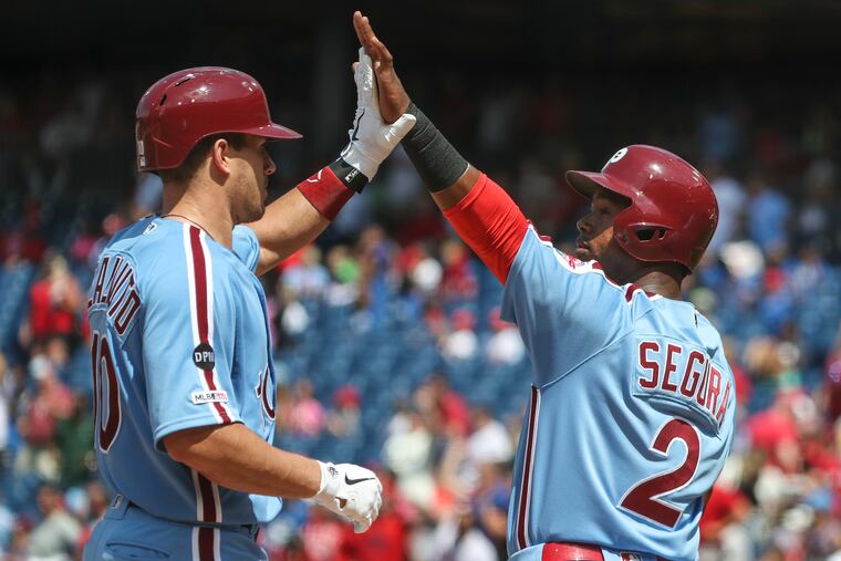 Phillies catcher J.T. Realmuto (10), left, high-fives Phillies infielder Jean Segura (2) after the Phillies scored four runs in the fourth inning of a game against the San Francisco Giants at Citizens Bank Park in Philadelphia, PA on Thursday, Aug. 01, 2019.