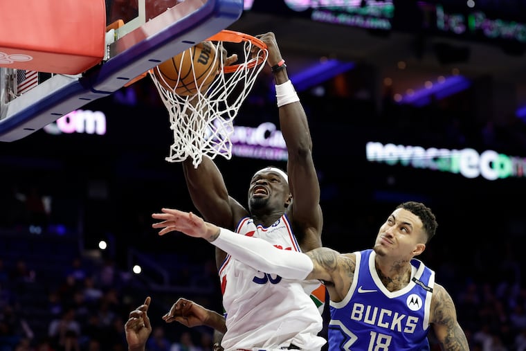 Sixers center Adem Bona dunks the basketball past Milwaukee Bucks forward Kyle Kuzma during the second quarter on Thursday, April 3, 2025 in Philadelphia.