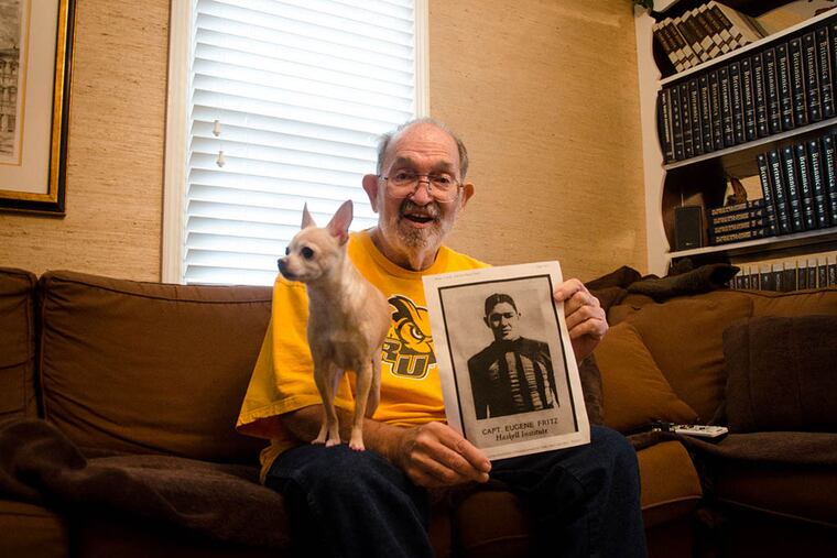 Former Rowan Univeristy Track Coach, Bill Fritz, with a photo of his father, William Fritz, in Moorestown N.J. on Mar. 26, 2015. ( MEAGHAN POGUE /Staff Photographer)