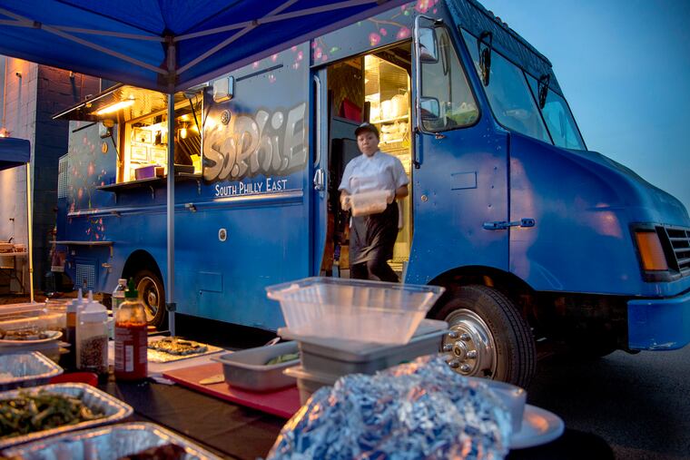 Chef Zing Thluai works in the South Philly East (SoPhiE) food truck at Novick Farm October 10, 2018. The nonprofit SEAMAAC is helping immigrants and refugees. They bought a food truck so immigrants who hope to open their own food business can try it out at the food truck first. TOM GRALISH / Staff Photographer