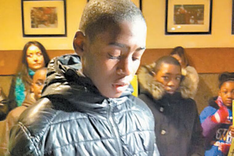 Khyrie Brown, 12, a seventh grader at LP Hill Elementary in Strawberry Mansion, reads a letter he wrote asking Mayor Nutter to stop the closure of his school. (Kristen Graham/Staff)
