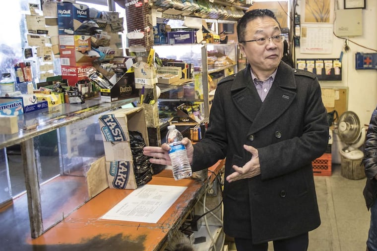 Adam Xu, chairman of the Asian American Licensed Beverage Association of Philadelphia, speaking at the Wayne Junction Deli, a beer deli in Logan, on Nov. 27, 2017, said the businesses need the barrier windows for safety reasons.