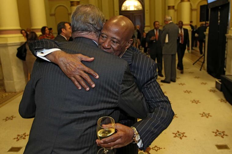 Bernard Watson (right), who with then-Mayor Ed Rendell got the Avenue of the Arts in motion, hugs Thomas McGill.