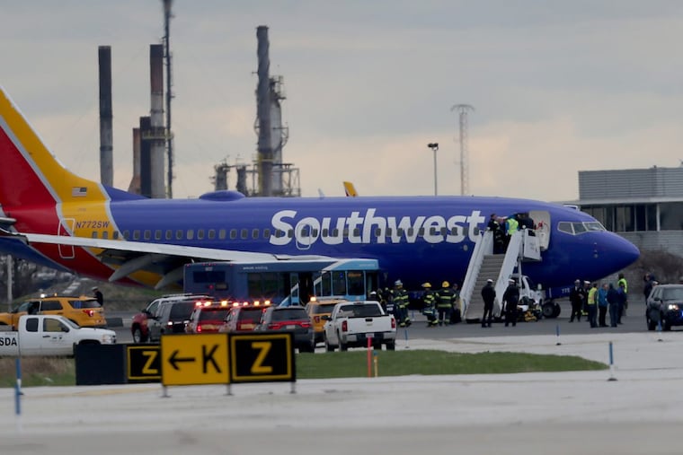 Southwest Airlines Flight 1380 sits on the runway after making an emergency landing at the Philadelphia International Airport.