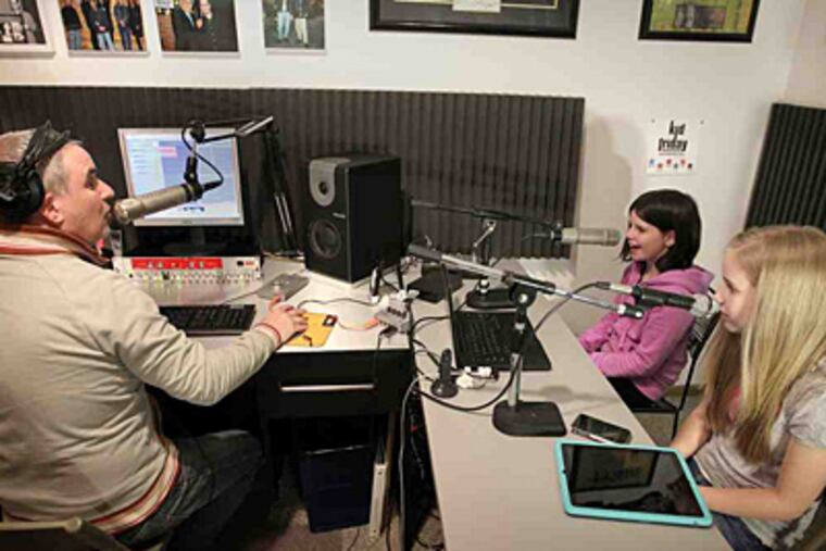 Dave Swerdlick and his daughters Hannah (right) and Zoe broadcast "Kid Friday" from their home in Plymouth, Minn. Swerdlick never reveals in advance the topics they'll talk about. (Tom Wallace/Star Tribune)