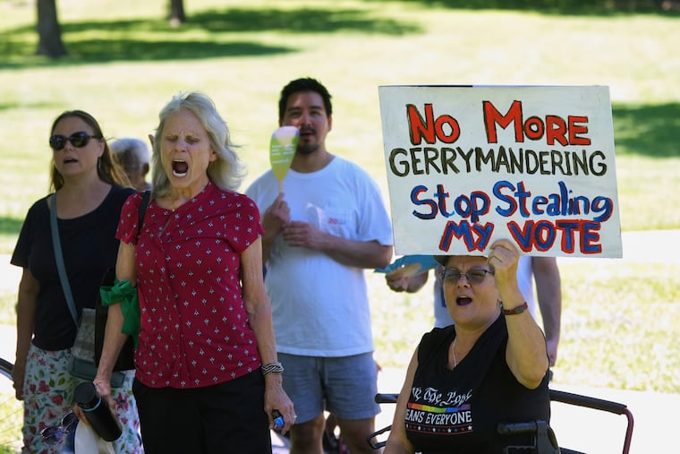 A woman holds a sign as she joins others during a rally to protest against redistricting hearings at the Texas Capitol, Thursday, July 24, 2025, in Austin.
