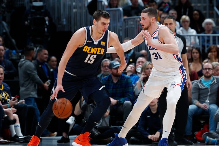 Mike Muscala tries to defend the Nuggets' Nikola Jokic on Saturday.