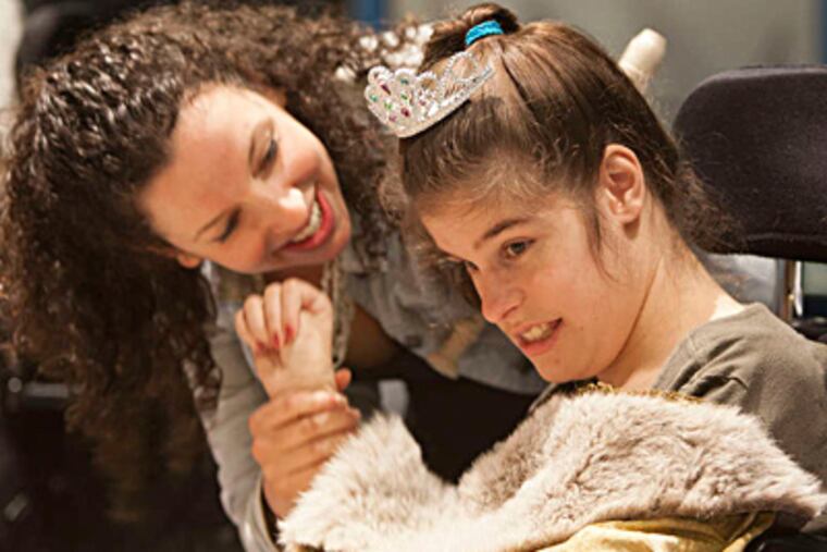 Samantha Pearlman (left) helps Amanda Long in a staging of "Hamlet" by HMS School for Children with Cerebral Palsy. ED HILLE / Staff Photographer
