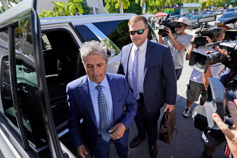 Carlos De Oliveira, center, an employee of Donald Trump's Mar-a-Lago estate, arrives for a court appearance with attorney John Irving, at the James Lawrence King Federal Justice Building on Monday in Miami.