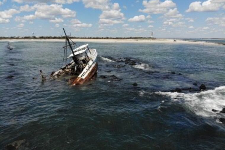 The Coast Guard is monitoring the fishing vessel Bay of Isles for potential pollution after it ran around at the Barnegat Inlet Jetty in N.J. and two fishermen were hoisted to safety.
