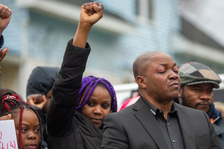 Peter Lyoya, right, father of Patrick Lyoya, closes his eyes as a tear runs down his face during the Justice for Patrick Lyoya march in Grand Rapids, Mich., on Saturday. The 26-year-old was killed during a traffic stop by a Grand Rapids police officer on Monday, April 4.