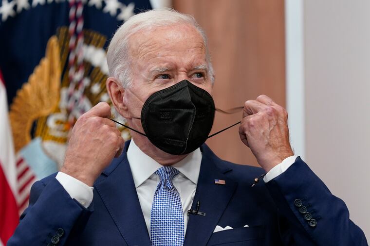 President Joe Biden removes his face mask as he arrives to speak about the economy during a meeting with CEOs in the South Court Auditorium on the White House complex in Washington on Thursday.
