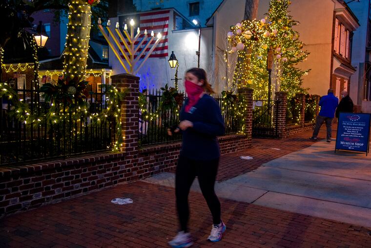 The first candle on the menorah in front of the Betsy Ross House glows on the first night of Hanukkah Dec. 10, 2020. Earlier in the evening a virtual lighting ceremony was conducted by the Old City Jewish Arts Center but wasclosed to the public due to COVID-19 restrictions. It was streamed live on Old City District’s Facebook page and covered by all the local television stations.