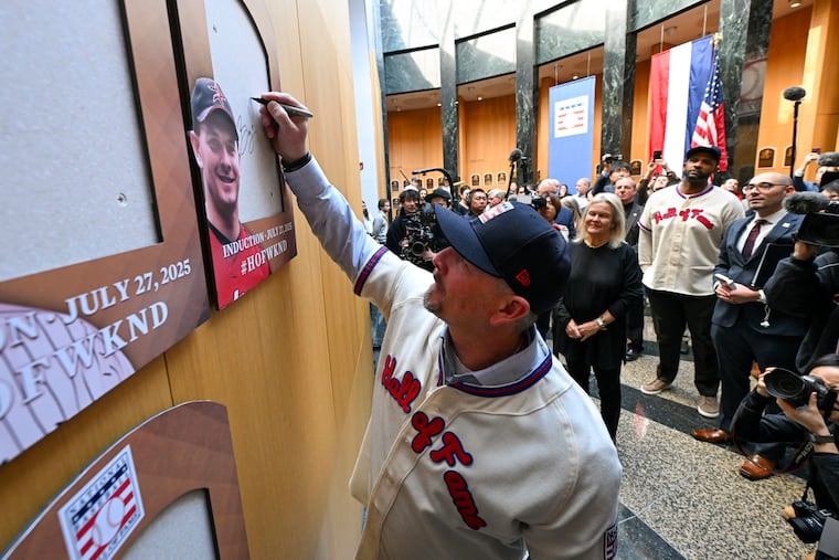 Baseball Hall of Fame member Billy Wagner signs the backer board where his plaque would hang before a January press conference following his Hall of Fame induction.