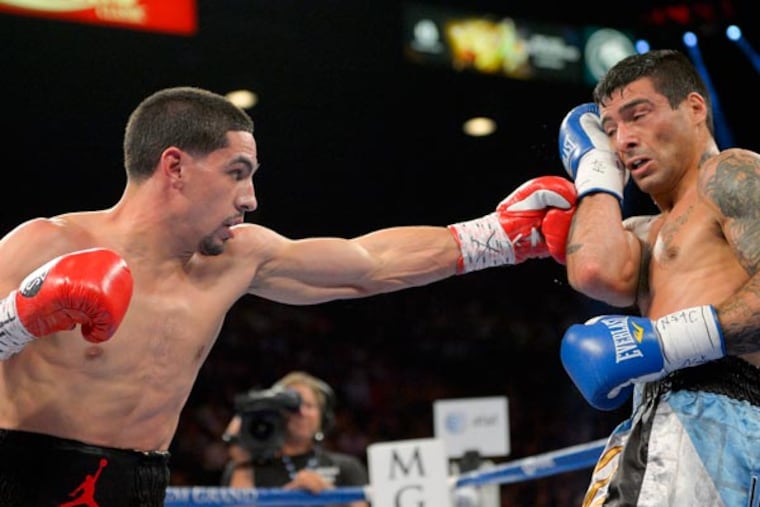 Danny Garcia (left) throws a jab against Lucas Matthysse in the third round during a WBC and WBA super lightweight title fight, Saturday, Sept. 14, 2013, in Las Vegas. (Mark J. Terrill/AP)