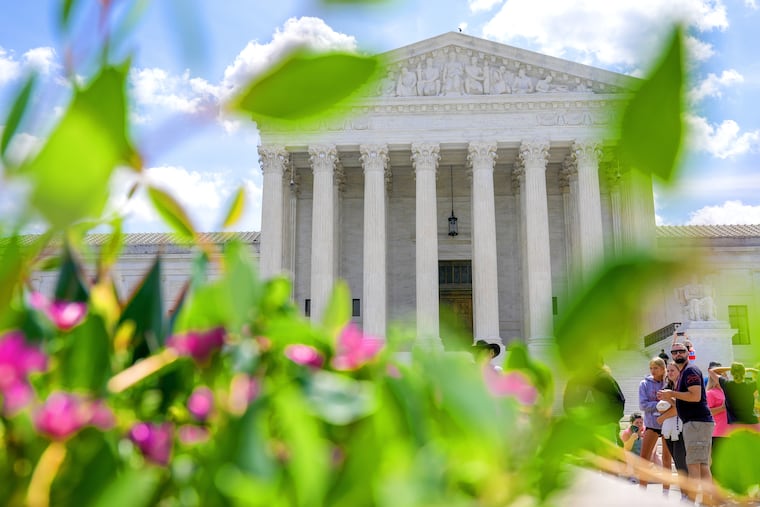 Visitors walk in front of the Supreme Court Friday, July 24, 2026, in Washington.