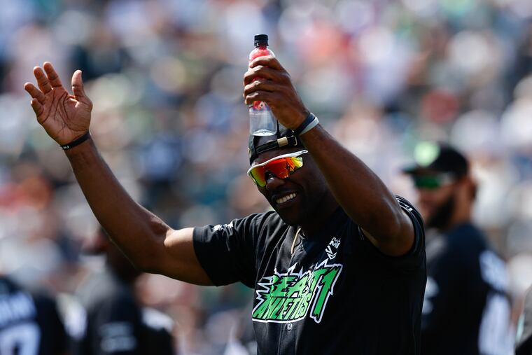 Former NFL wide receiver Terrell Owens cheers on fans during the DeVonta Smith & Friends celebrity softball game on Saturday at Coca-Cola Park in Allentown.