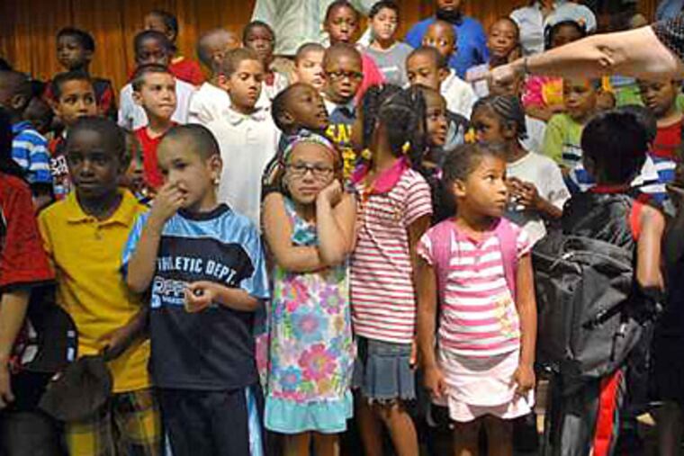 Elementary students are lined up in the auditorum to move to their classrooms at Stearne School in Frankford. Their older peers across the Philadelphia School District showed improvements in reading and math on state standardized tests, officials said Monday. (Tom Gralish / Staff / File)